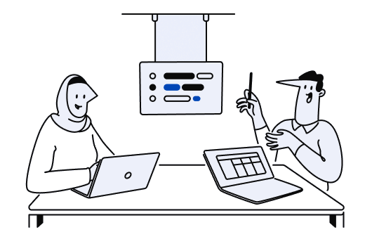 Two people working together at their desks